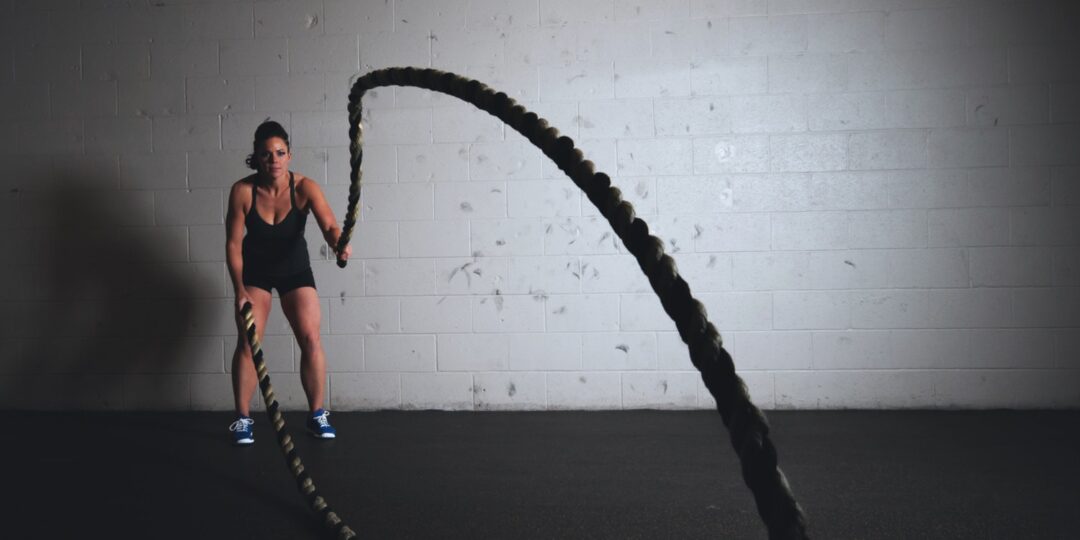 woman working out with heavy ropes