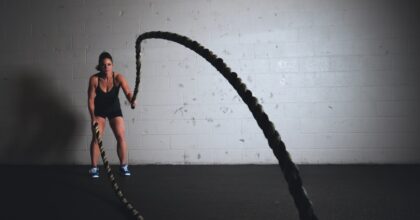 woman working out with heavy ropes