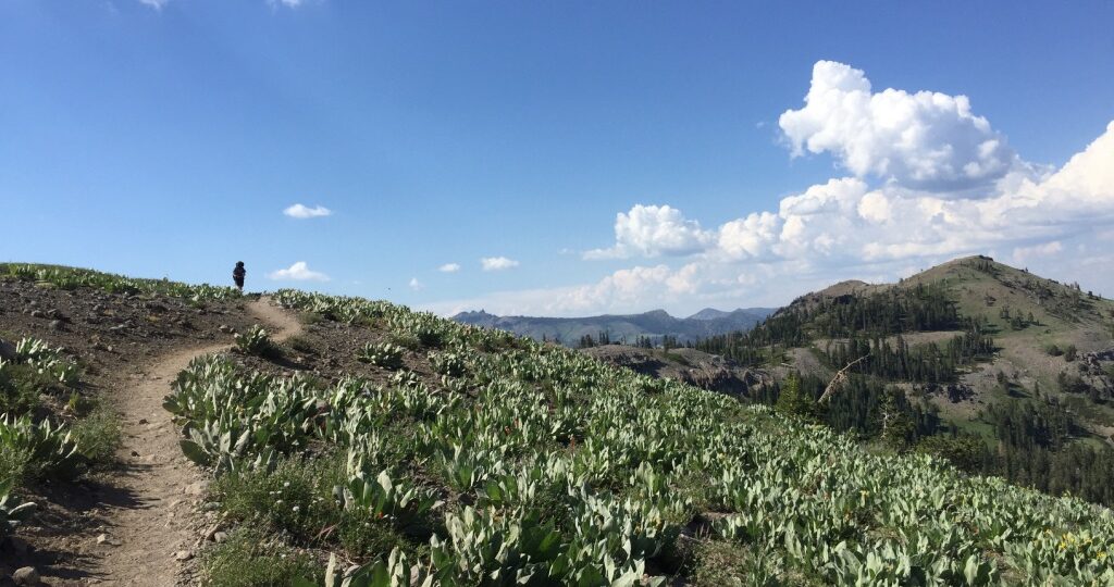 Person walking along a ridge in the mountains