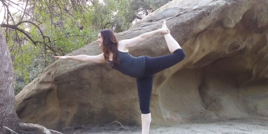 yoga instructor in dancer pose