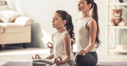 Mother and Daughter meditating on yoga mats