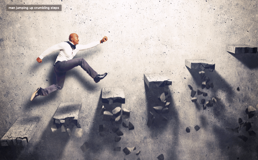 man jumping up crumbling steps