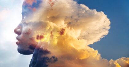 meditating head merged with clouds ins sunset