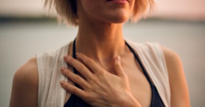 woman meditating with eyes closed and hand over heart