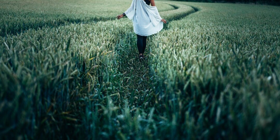woman walking in green countryside