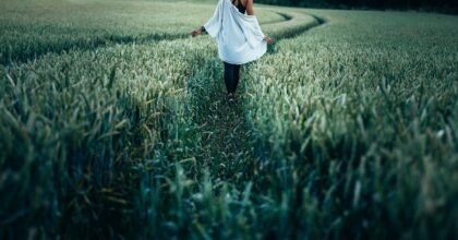 woman walking in green countryside