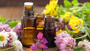 bottles essential oils and flowers